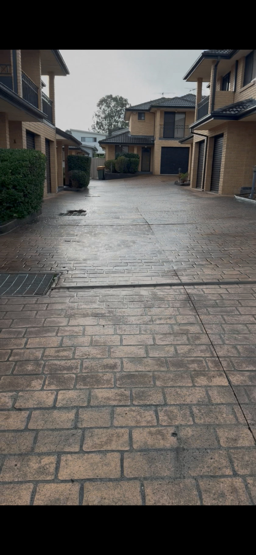 Long paver driveway after pressure washing